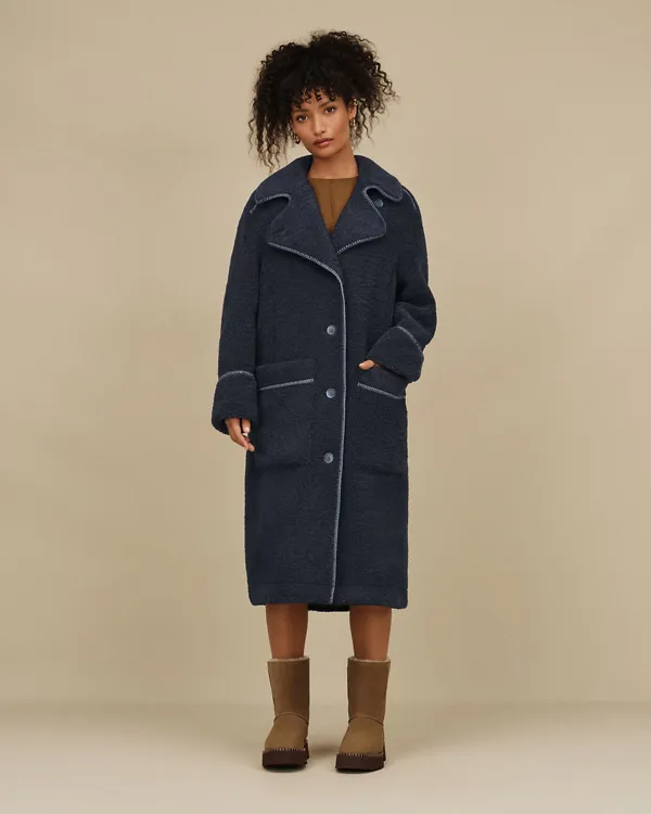 A woman wearing our Sema UGGfluff Coat and Uptowner Short Boot.